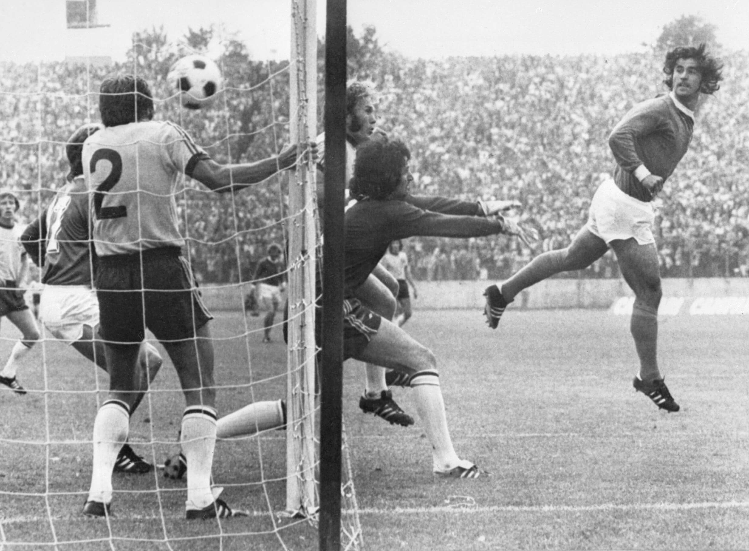 Gerd Müller guides a header beyond Australia goalkeeper Jack Reilly and defender Doug Utjesenovic at the 1974 World Cup
