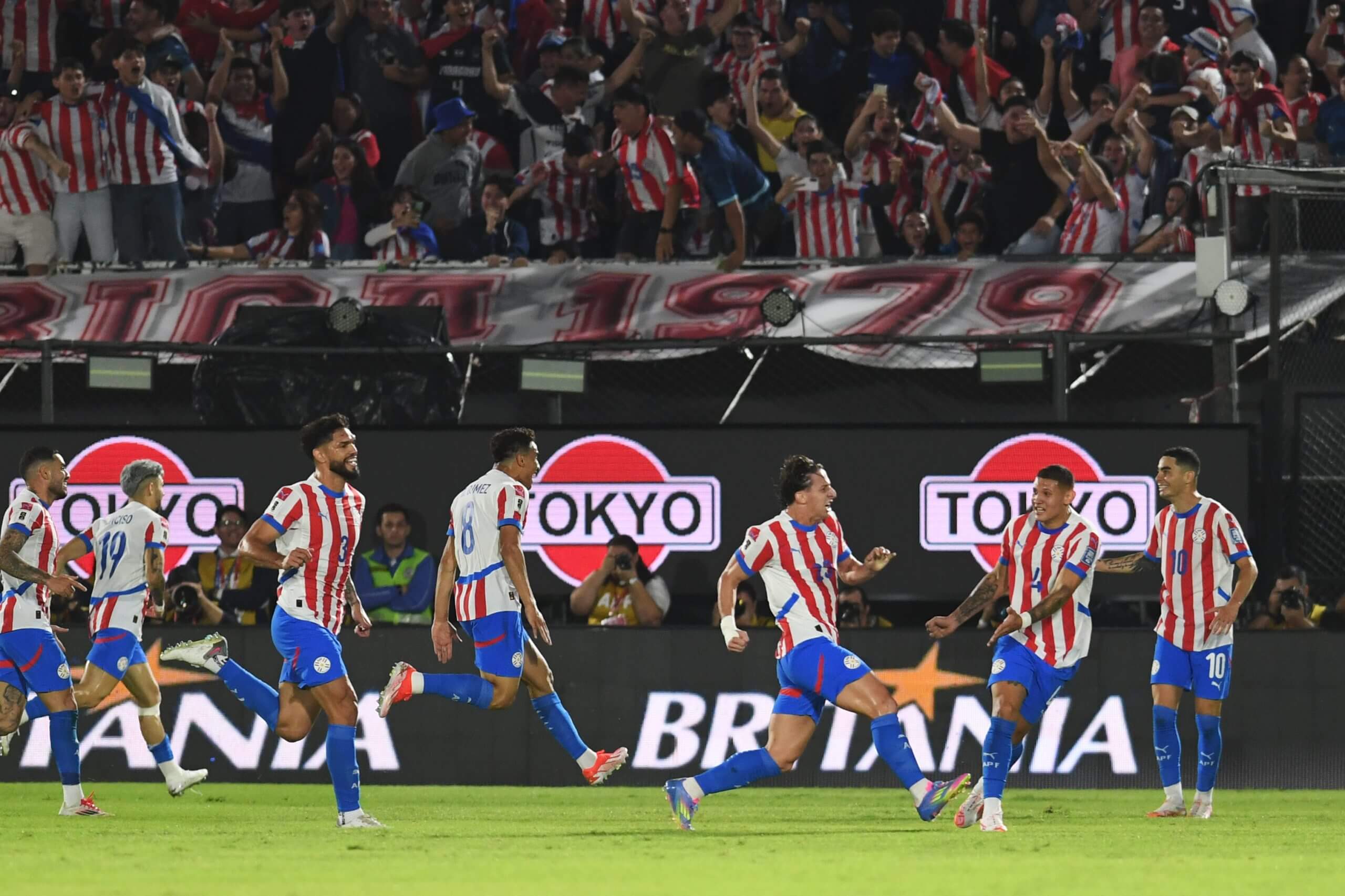 Paraguay players celebrate a World Cup qualifying goal vs Uruguay
