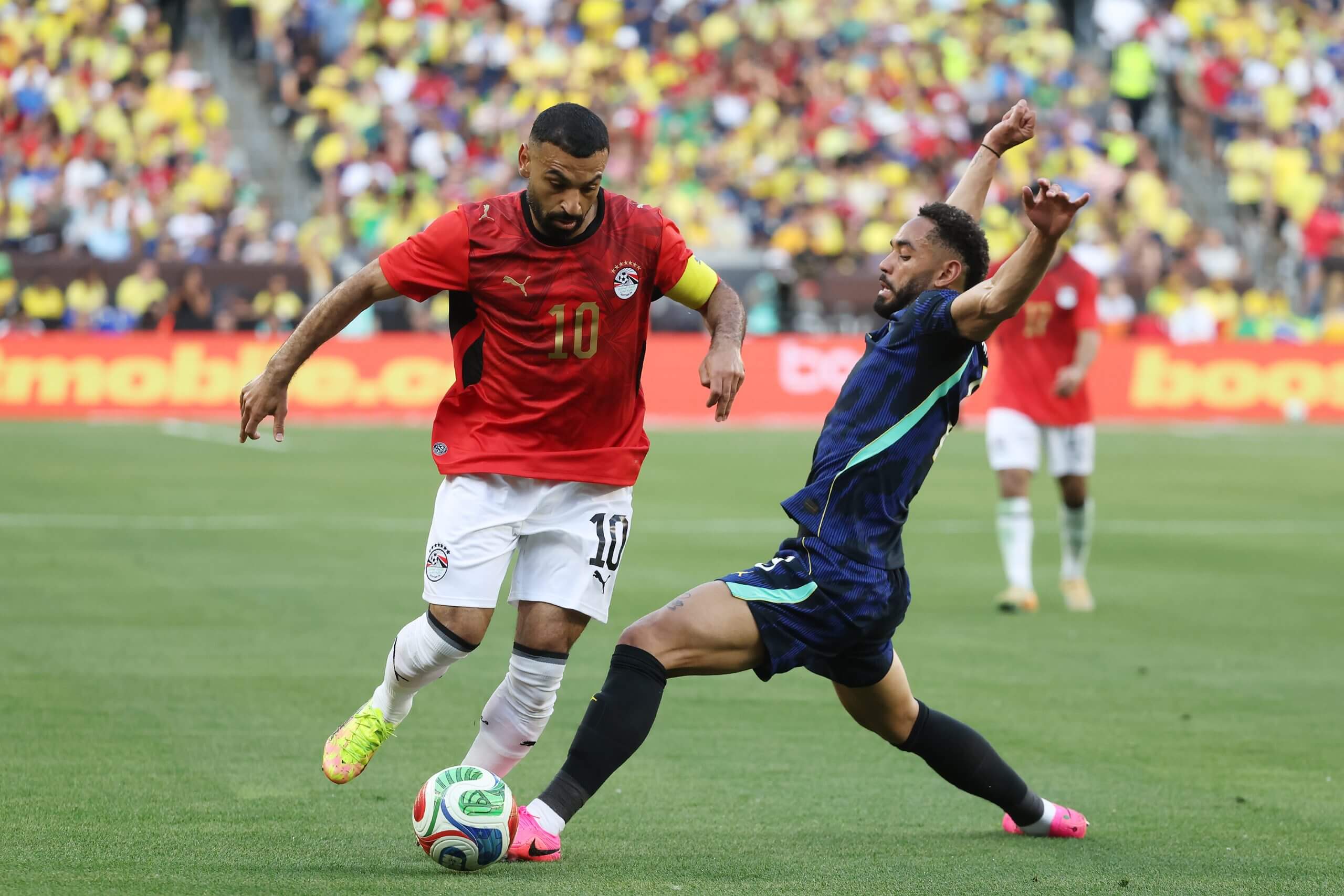 Mohamed Salah evades a challenge from Brazil's Matheus Cunha