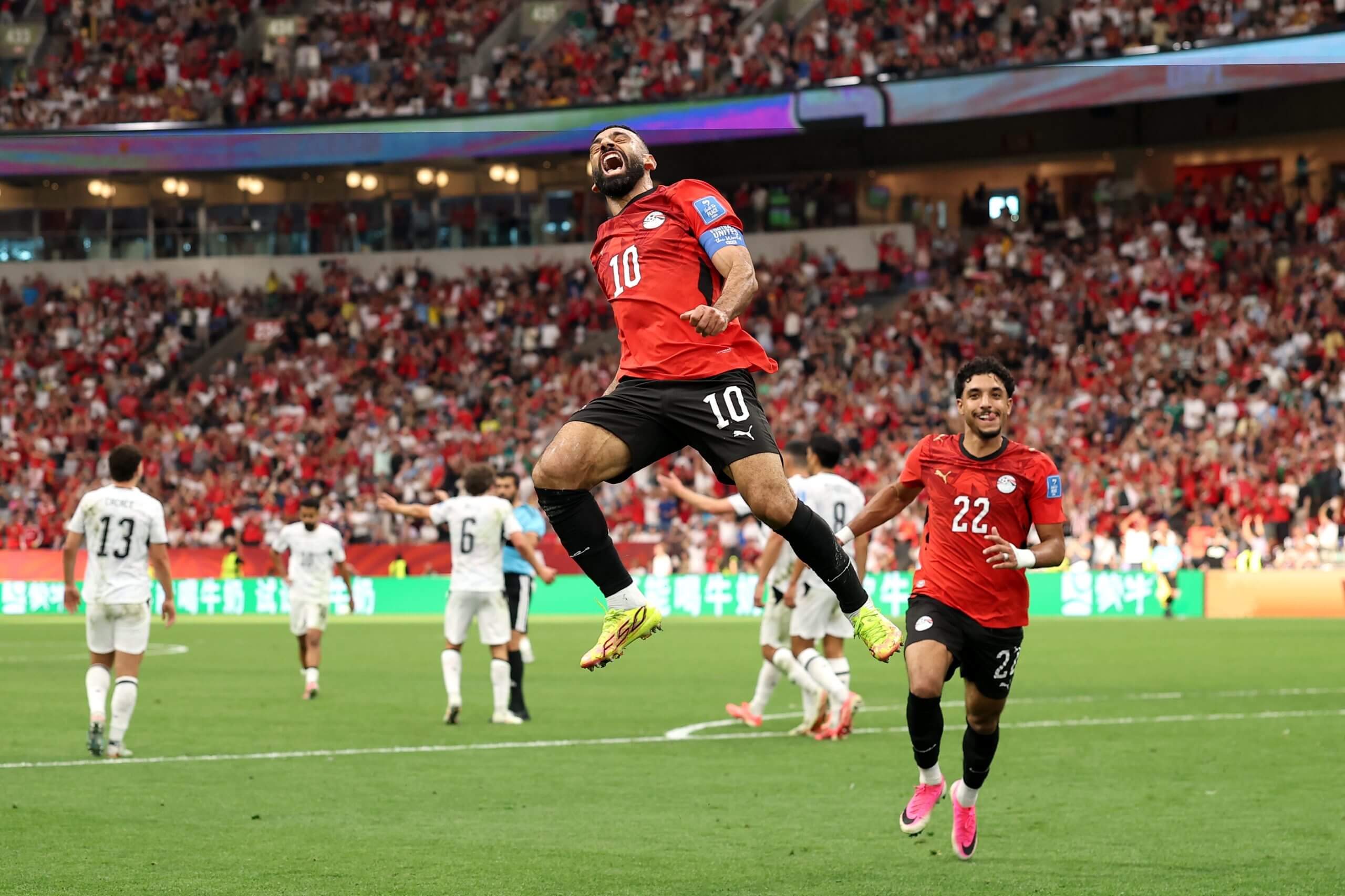 Mohamed Salah leaps into the air as he celebrates his goal for Egypt against New Zealand