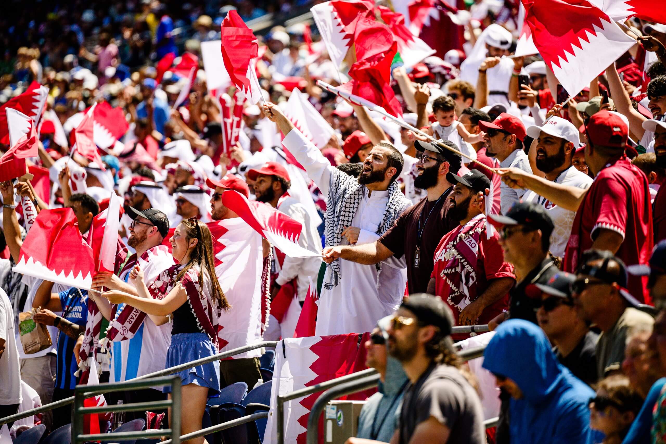 Qatar fans wave flags as they support their team against Bosnia and Herzegovina 