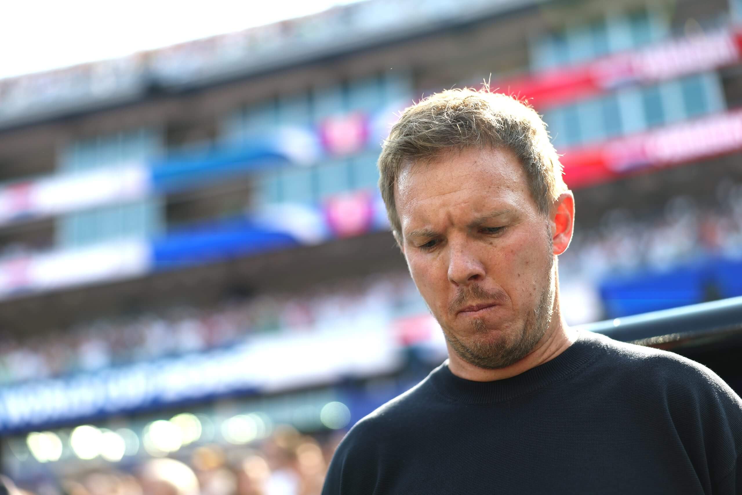Nagelsmann looks down at the ground from his position on the sidelines of Germany vs Paraguay