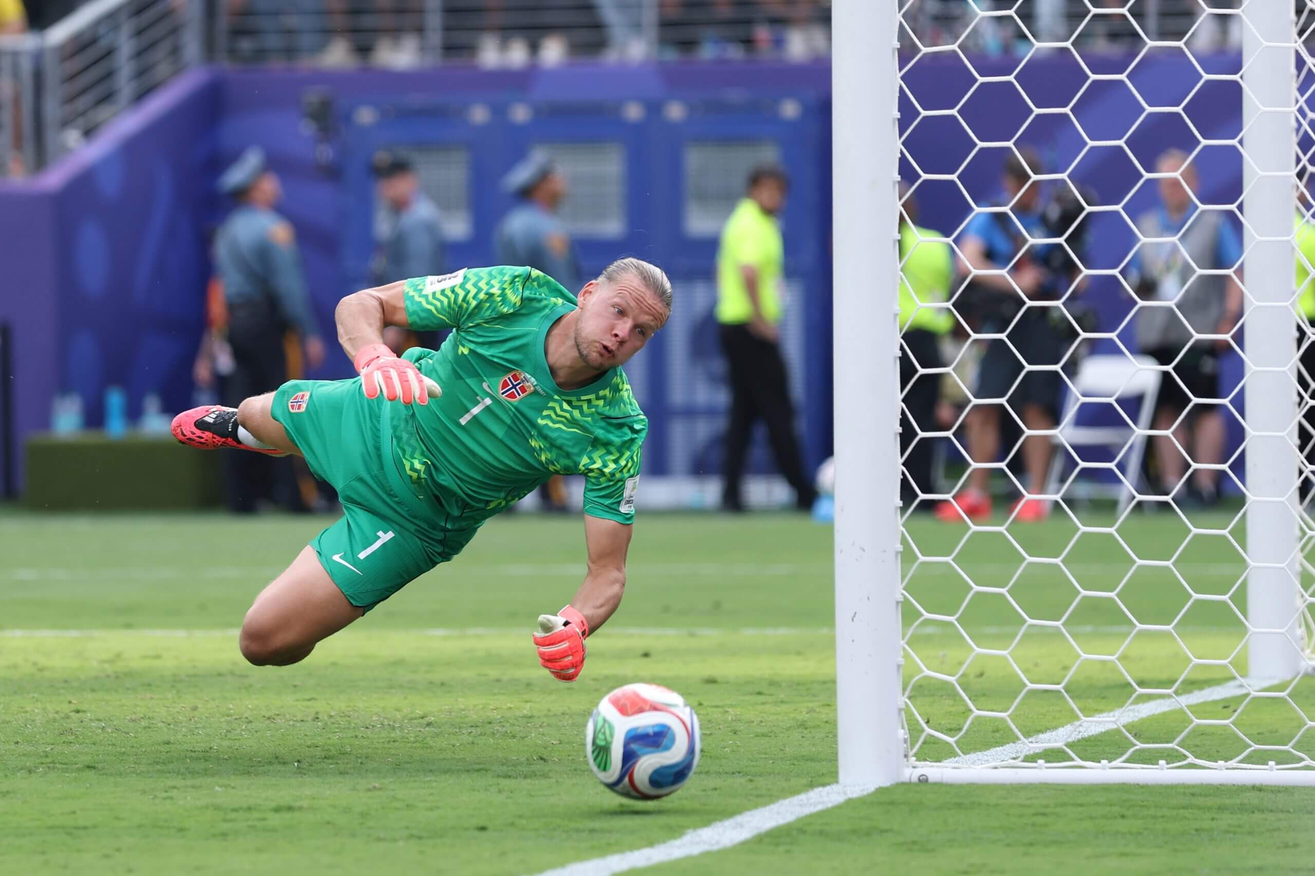 Orjan Nyland pushes a shot round the post