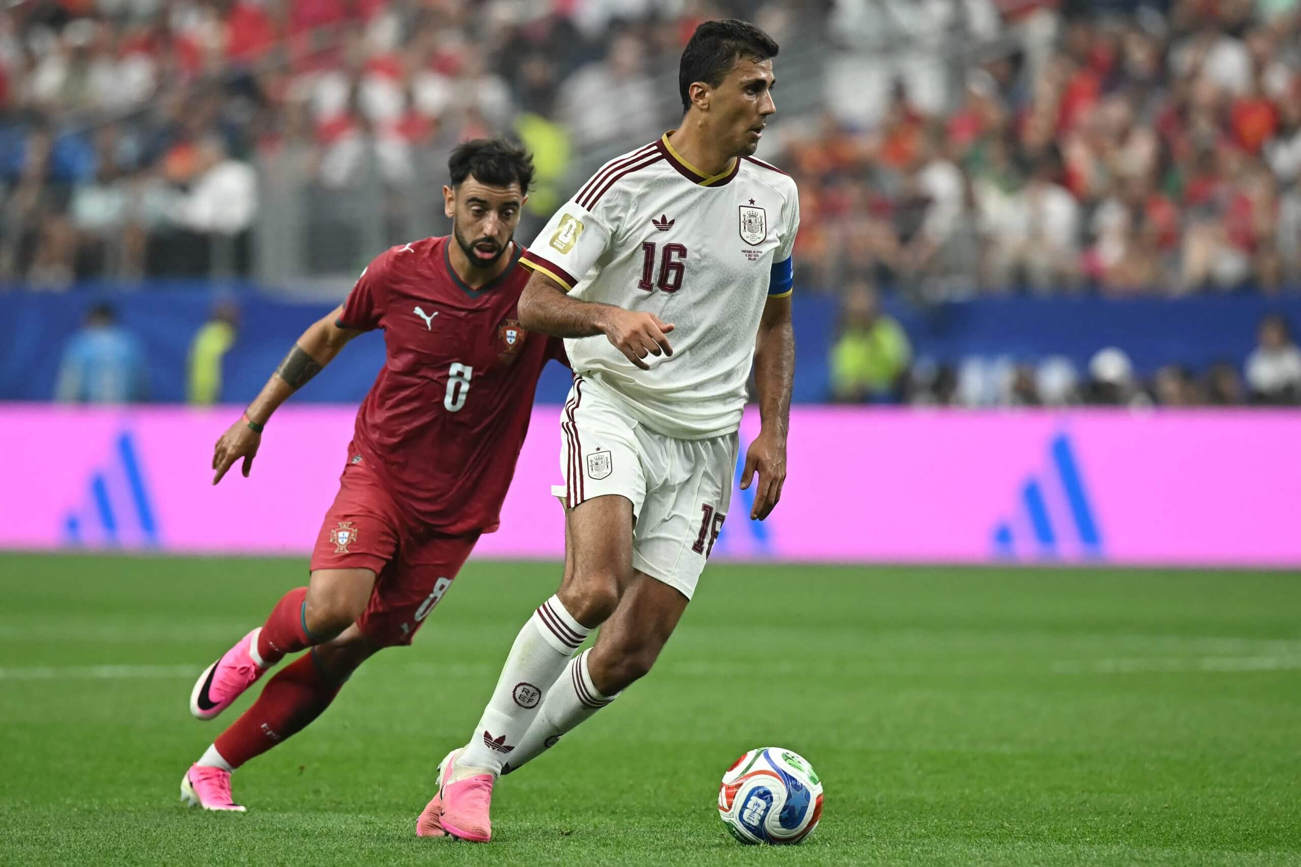 Rodri shields the ball from Portugal's Bruno Fernandes