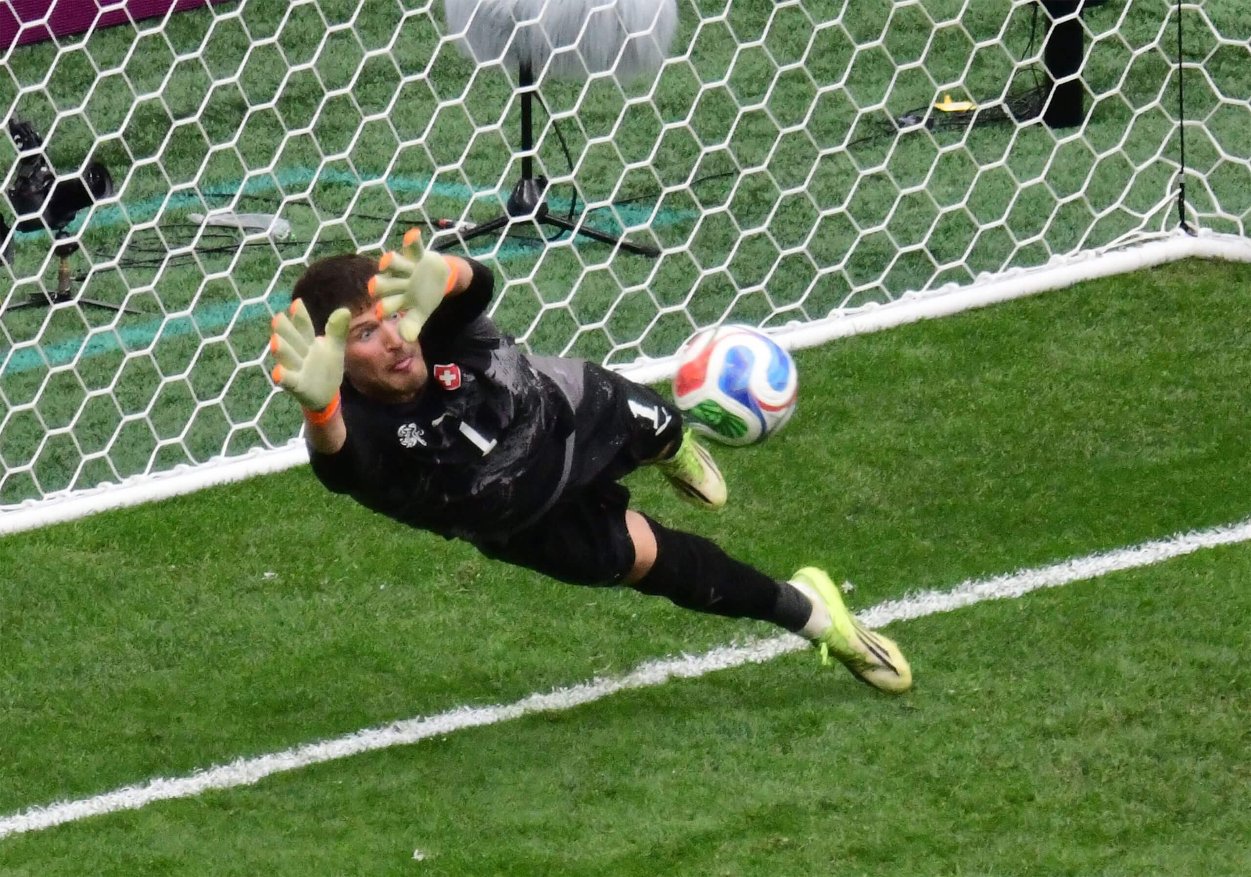 Gregor Kobel dives to block a Colombian penalty in the shootout