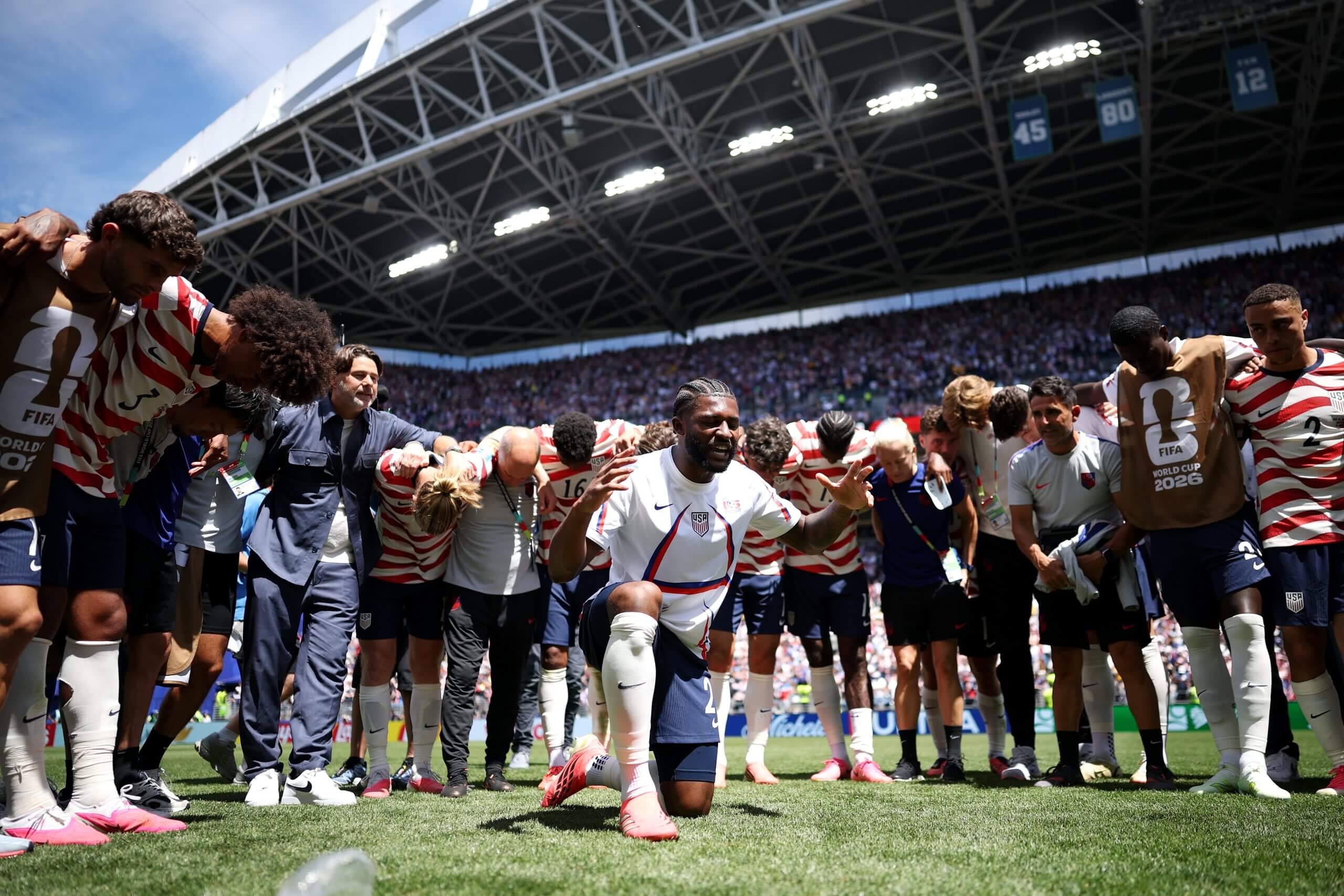 Mark McKenzie at the center of a USMNT postgame circle