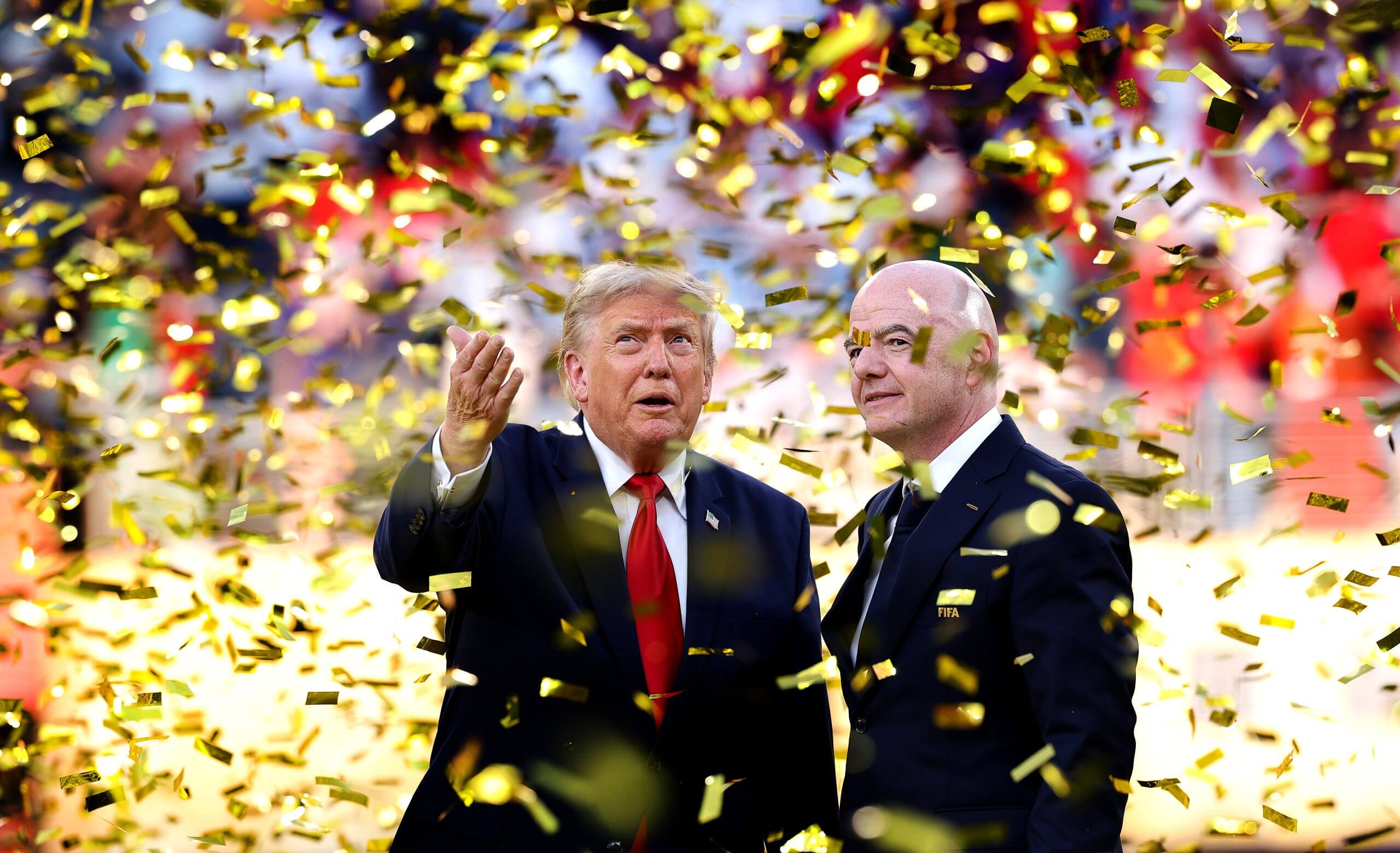 U.S. President Donald Trump and FIFA president Gianni Infantino converse while confetti falls during Spain's trophy celebration