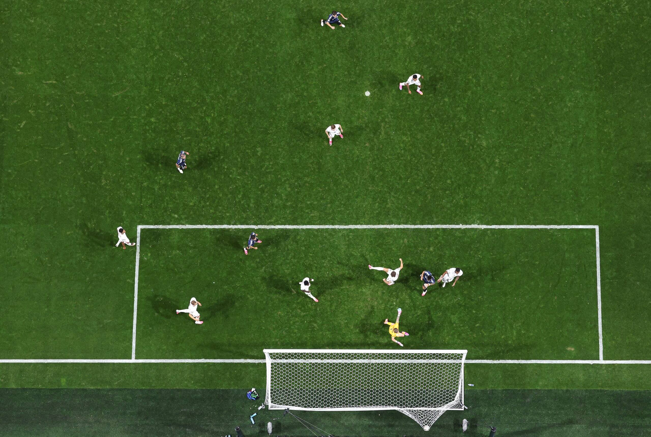 An aerial shot of England'a penlty area, shortly after Lautaro Martinez heads Argentina's second goal in the World Cup semi-final. The ball is bulging into the net as players from both teams react 